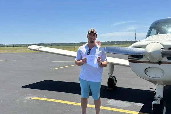 Student holding pilot certificate