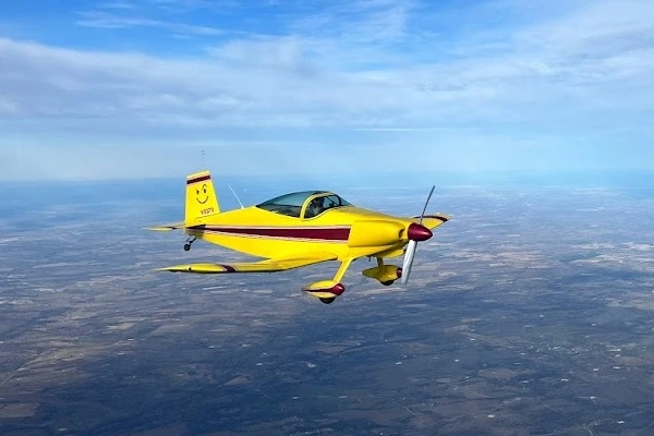Single engine airplane flying over a landscape